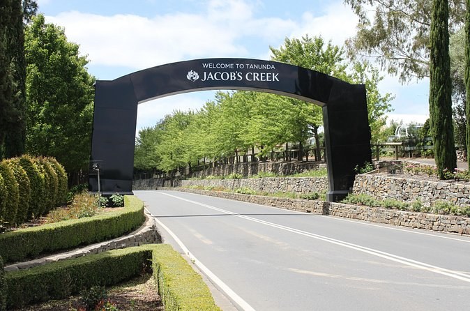 The Jacob's Creek arch welcoming drivers to Tanunda, hedges and vines alongside